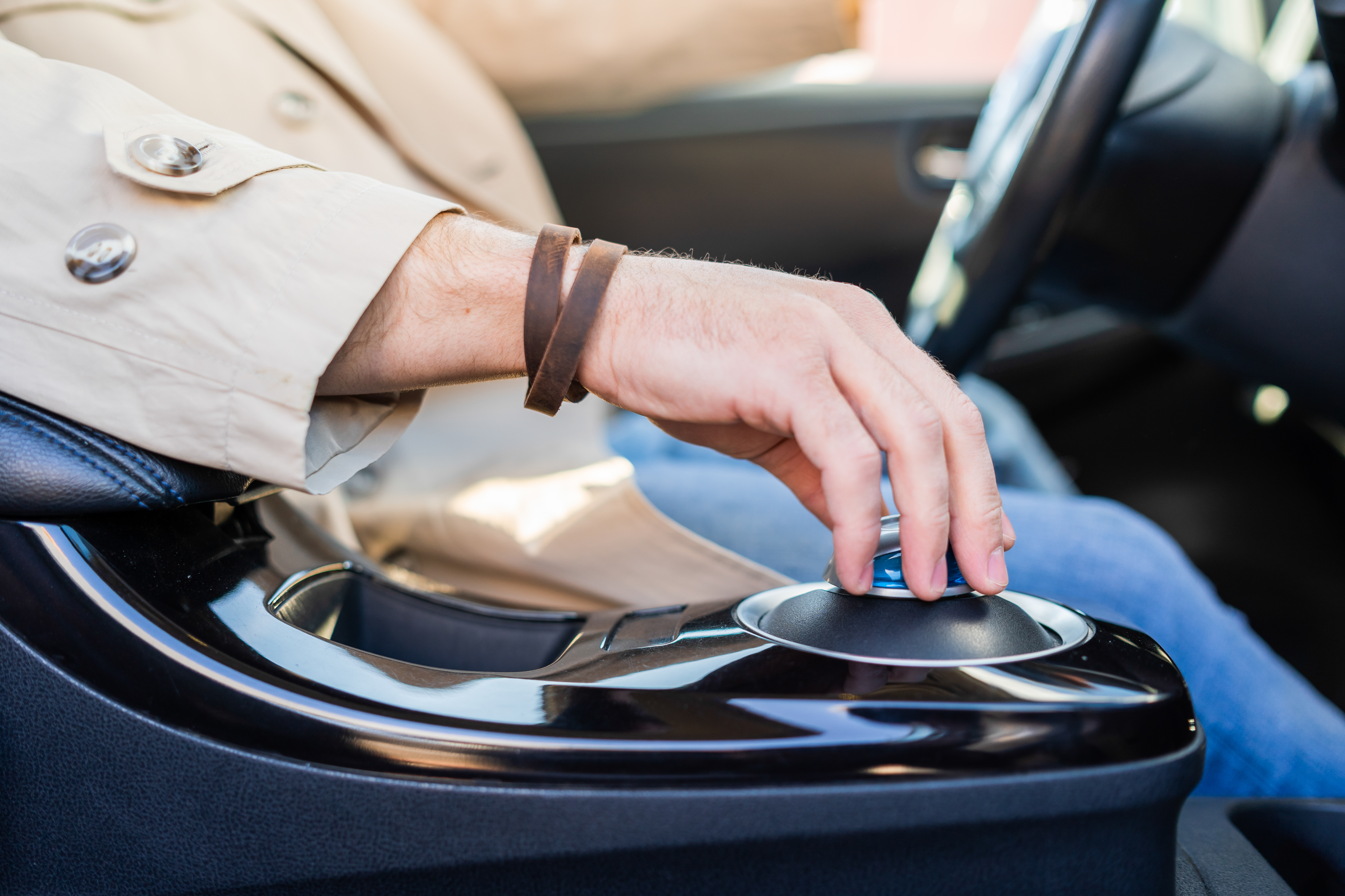 Man holds his hand on the gear shift in modern electric car; Shutterstock ID 1982369309; purchase_order: ; job: 11797809; client: Hertz US; other: Anastasiia