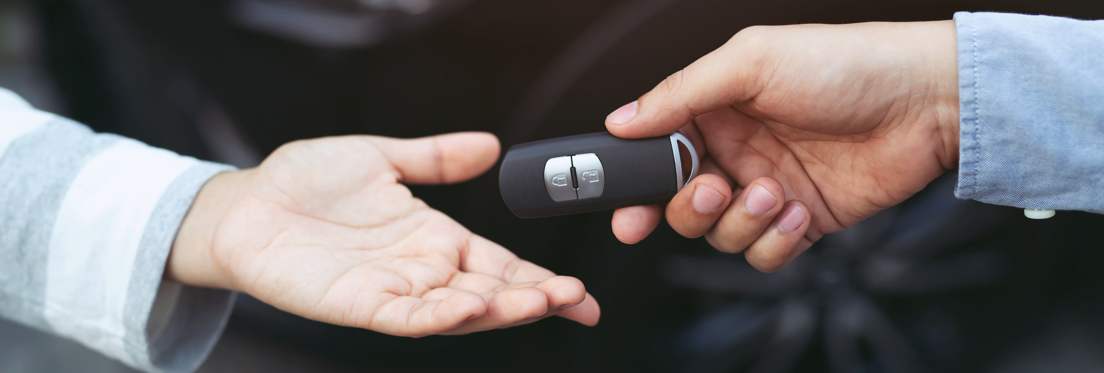 Car key being given from hand to hand