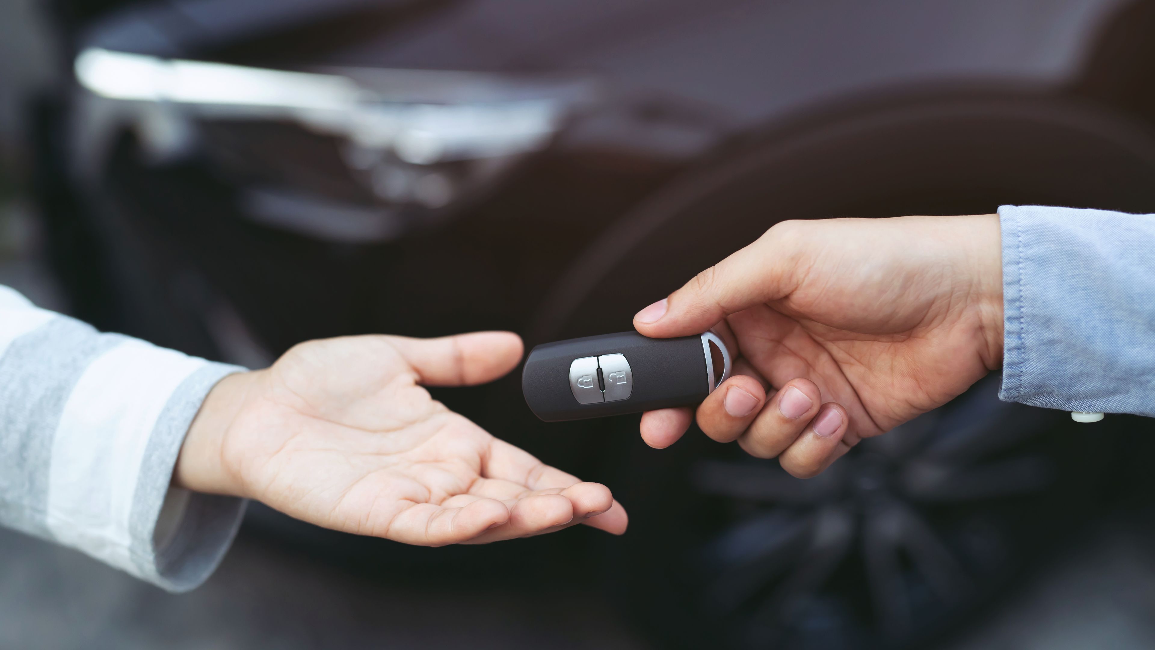 Car key being given from hand to hand
