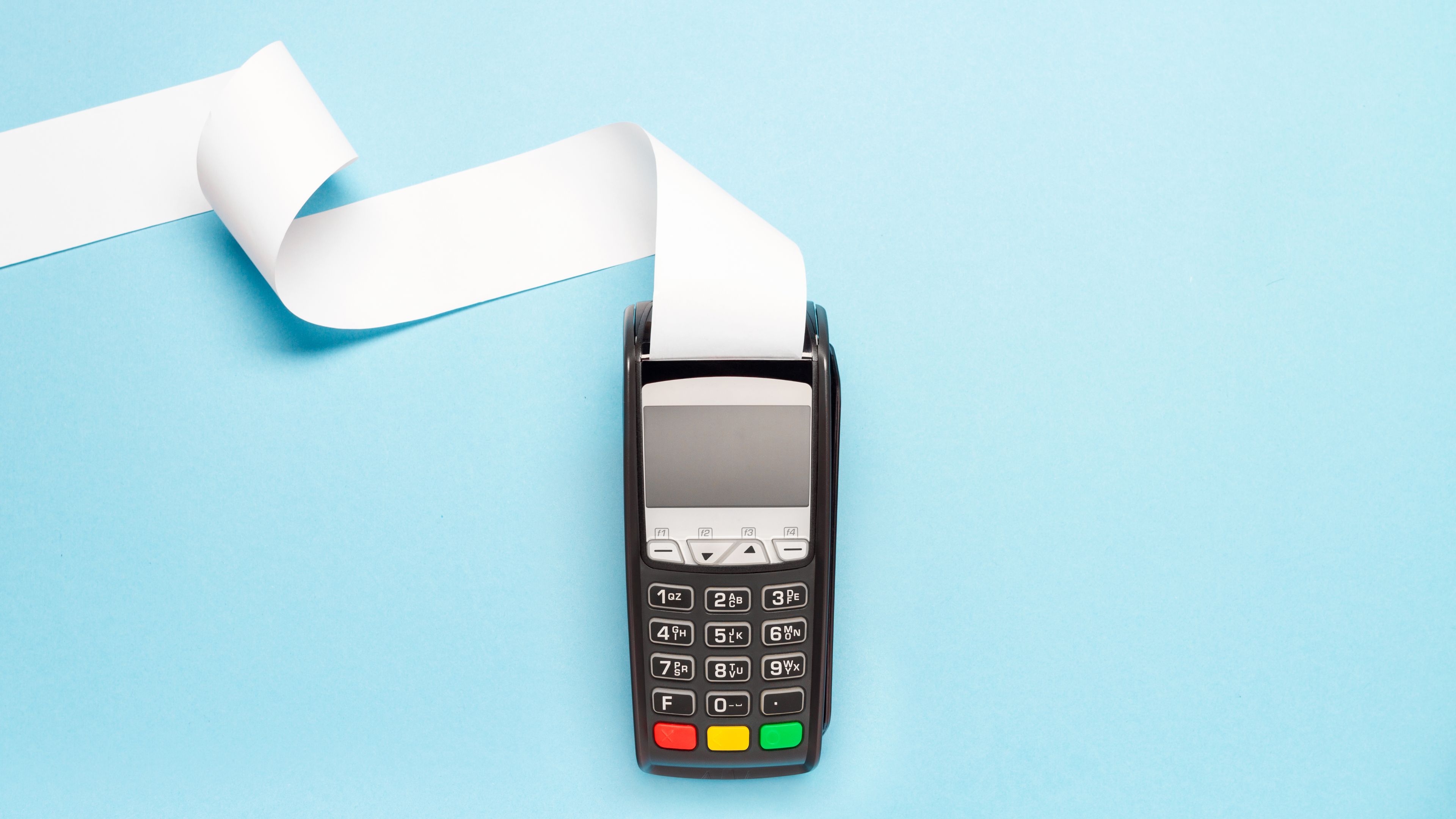 A card machine printing a receipt