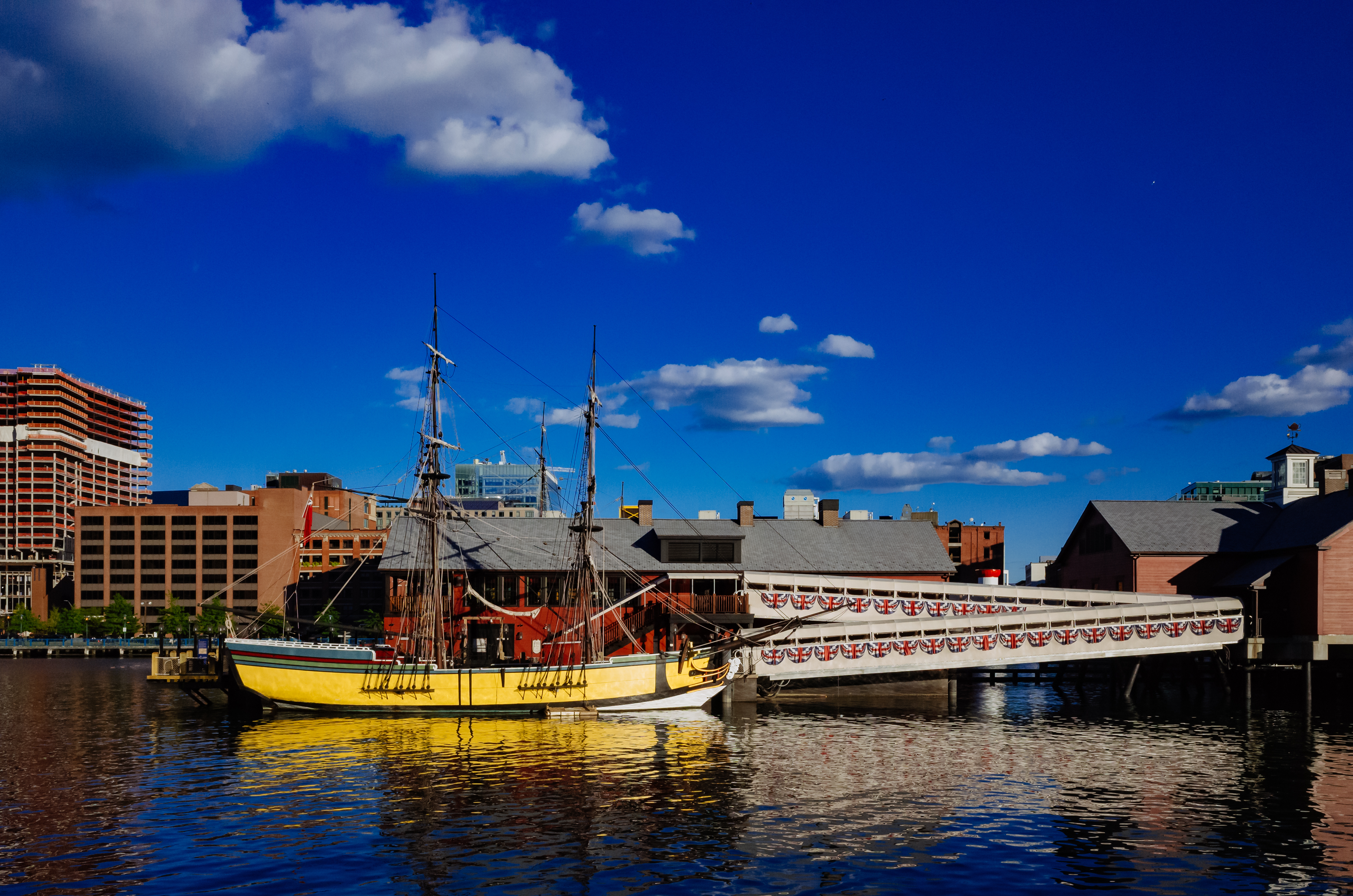 View of Boston Tea Party Ship & Museum over Fort Point Channel under blue sky in downtown Boston, USA; Shutterstock ID 1218883162; purchase_order: ; job: 1287385; client: Hertz US; other: Anastasiia