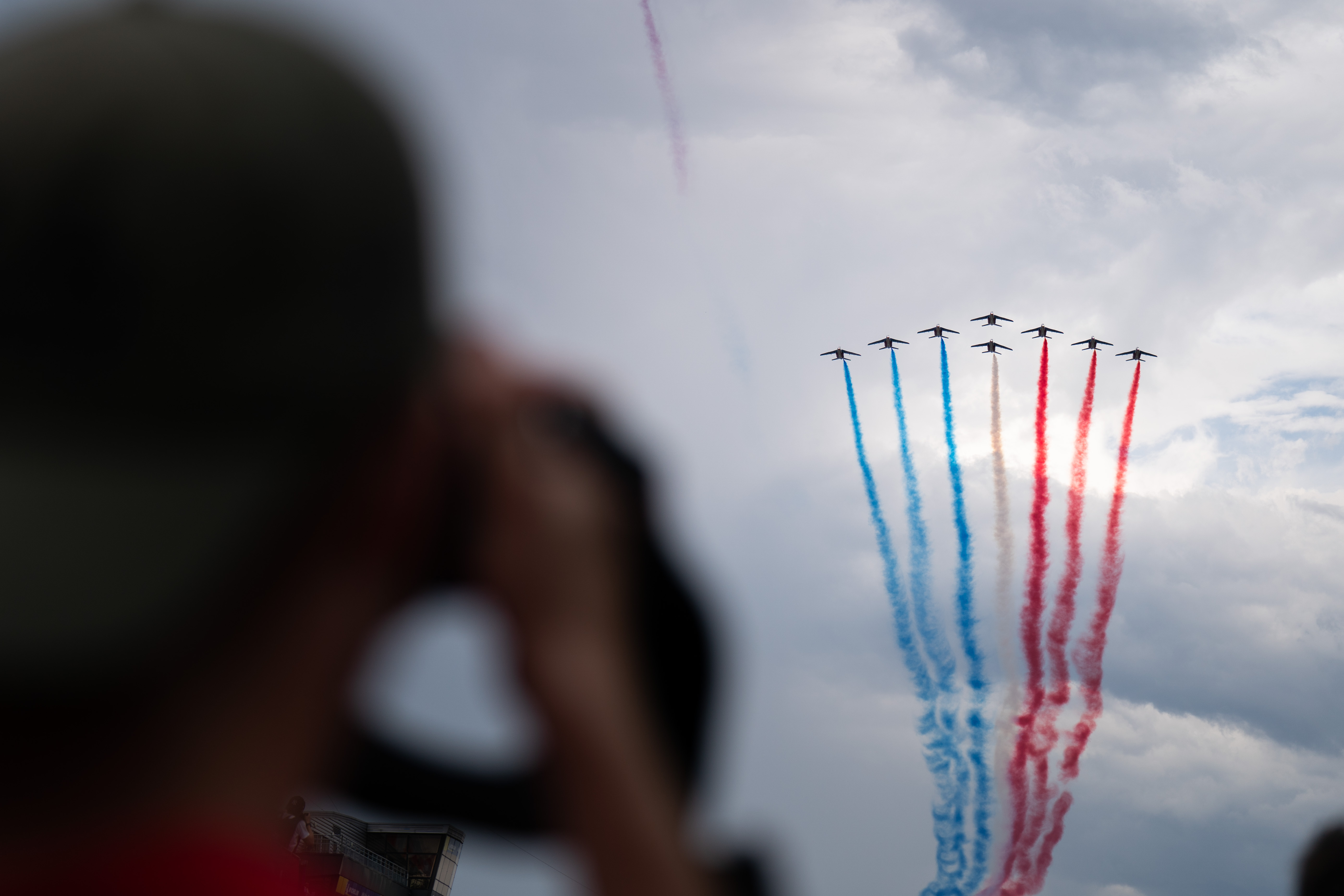 air show displaying france flag colours