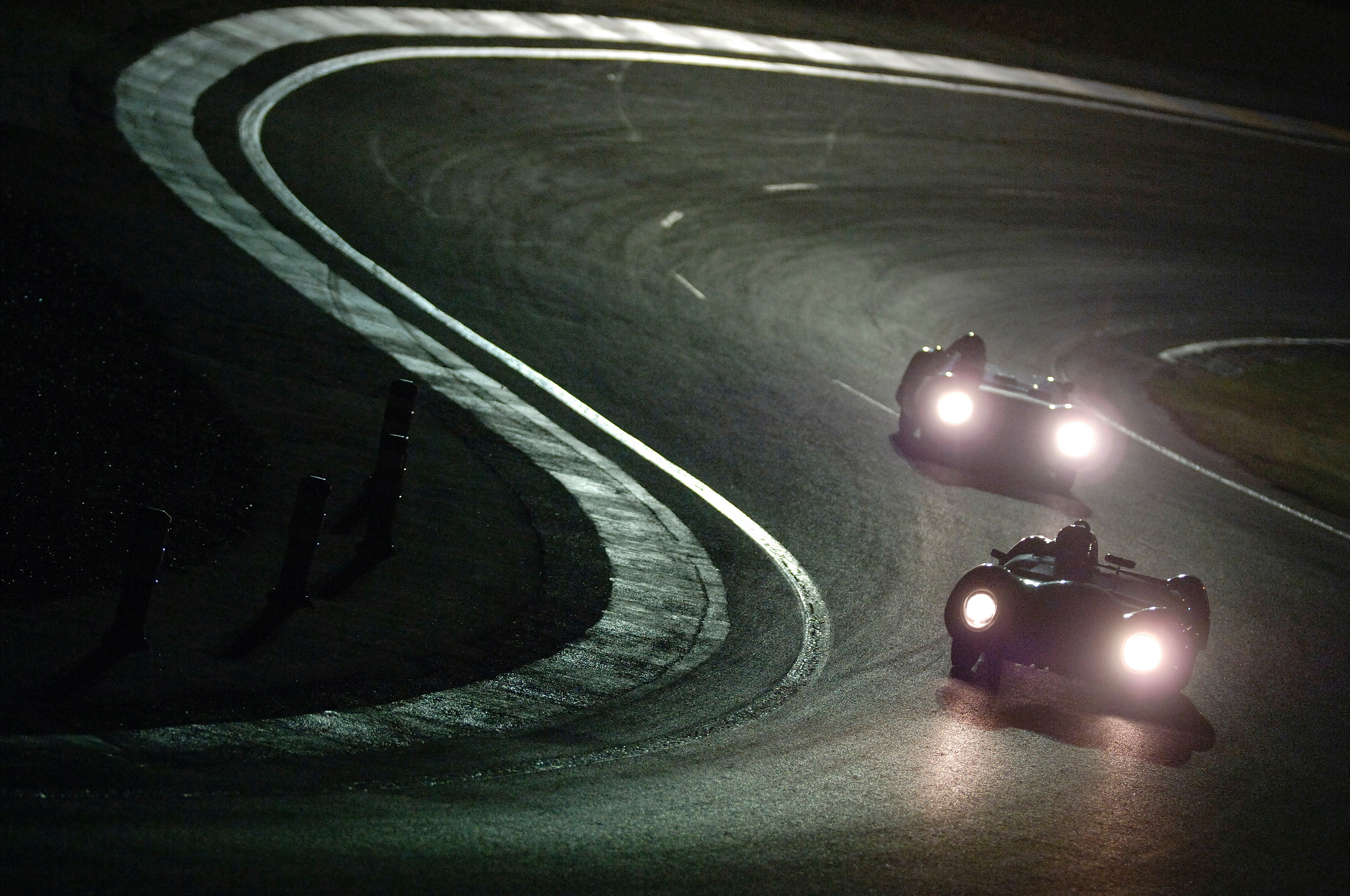 endurance historique cars racing in race track in the evening