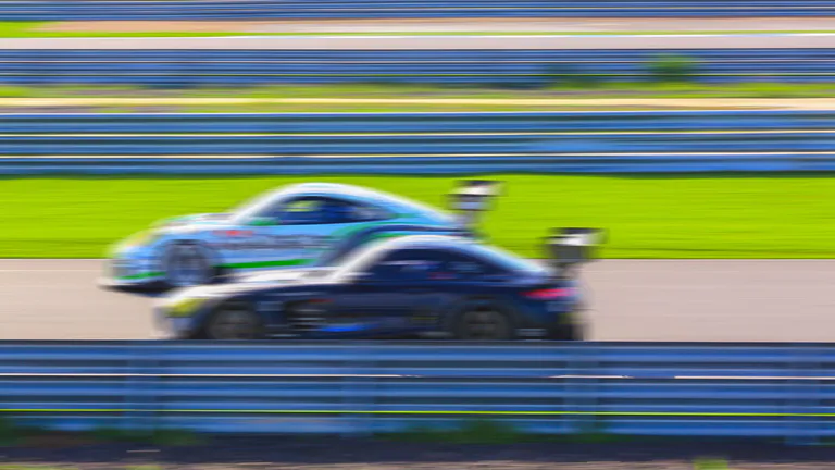 cars racing with speed on a race track