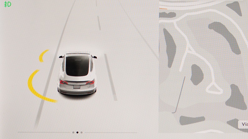Tesla Car display screen showing Autopilot with car icon and map of driving location