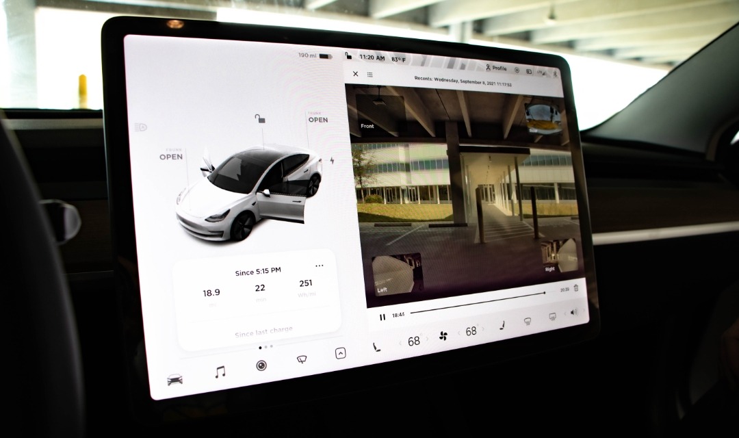 Interior view of display screen in Tesla Model 3 showing rearview camera feed.