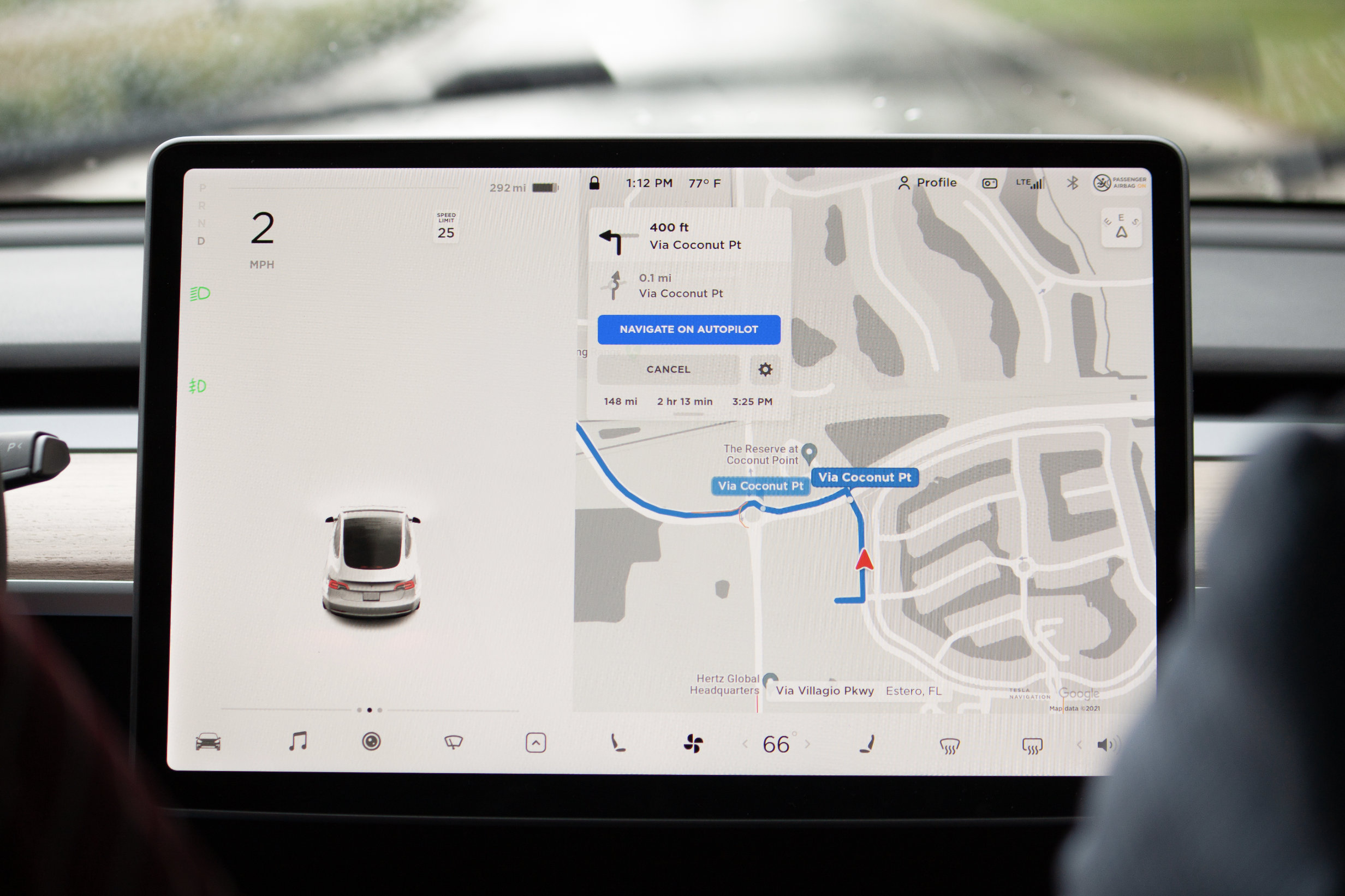 Tesla Model Y display screen showing Autopilot with car icon and map of driving location